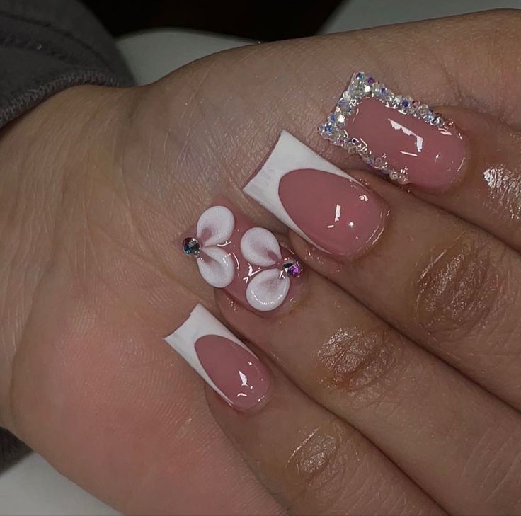 Elegant Floral Nail Design with Soft Pink Base and Rhinestone Accents.