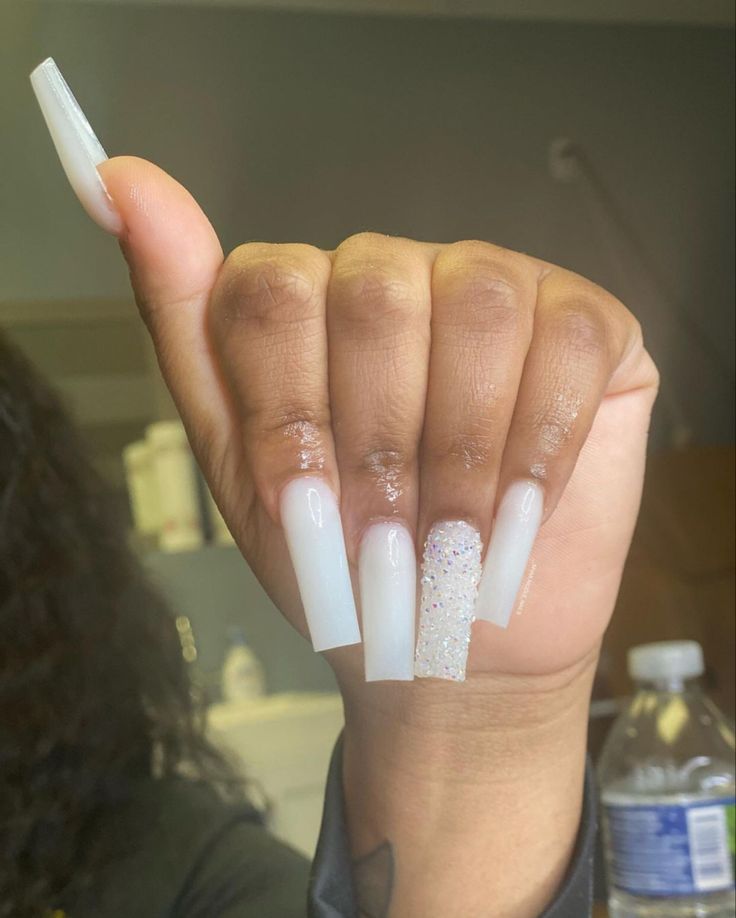 Chic Long Nail Design: Translucent White with Glitter Accent for a Modern Sophisticated Look.