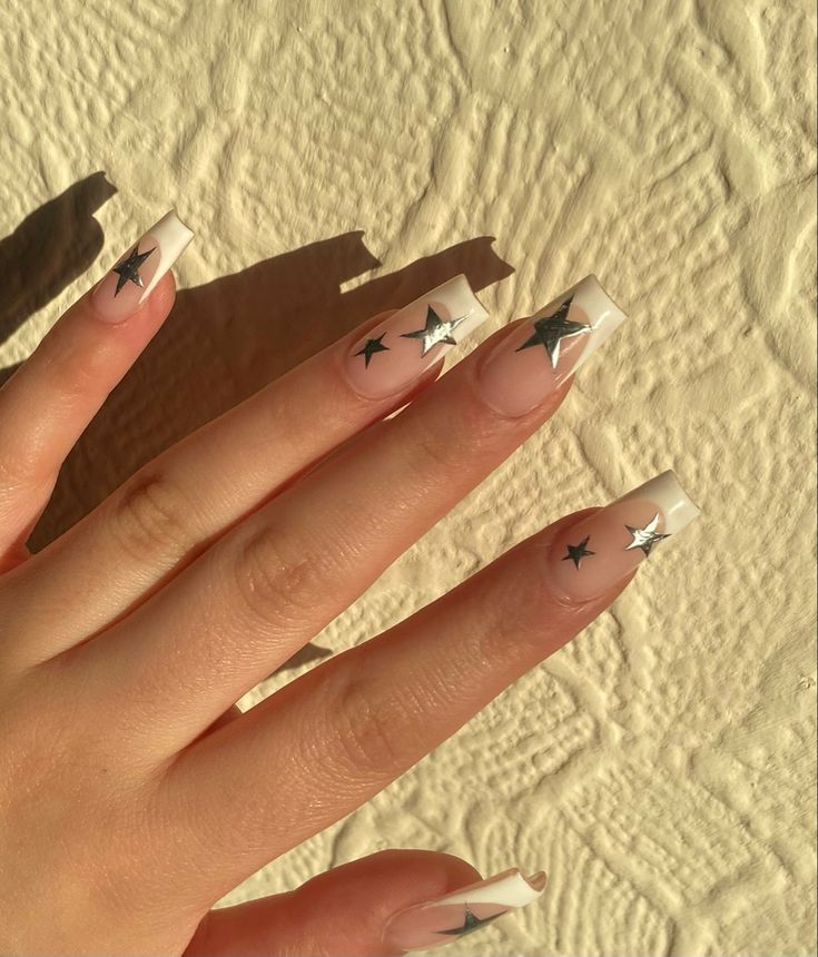 Chic Neutral Nail Design with White Tips and Whimsical Star Embellishments.