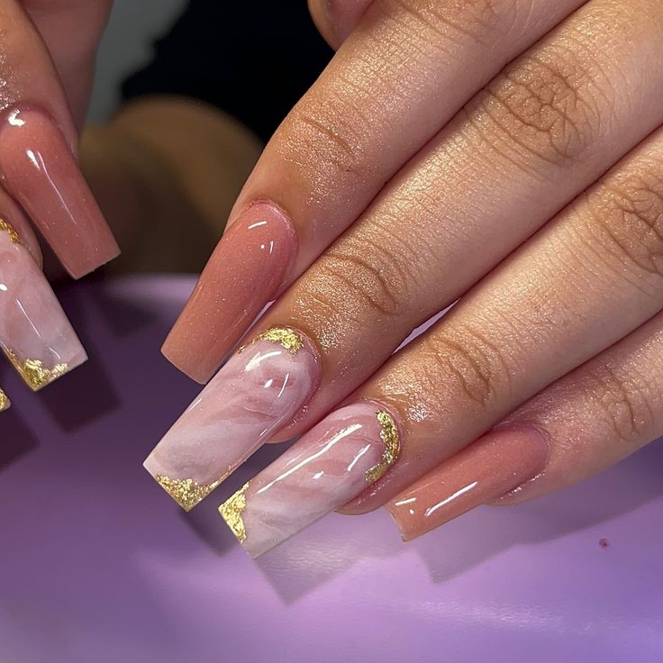 Elegant Peach and Marble Nail Design with Glamorous Gold Foil Accents