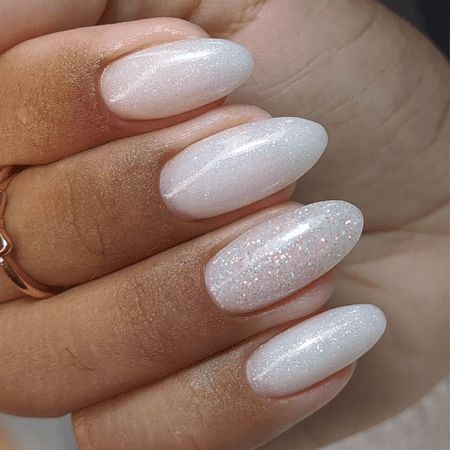 Sophisticated Almond-Shaped Ombre Nail Design with Sheer White and Subtle Glitter.