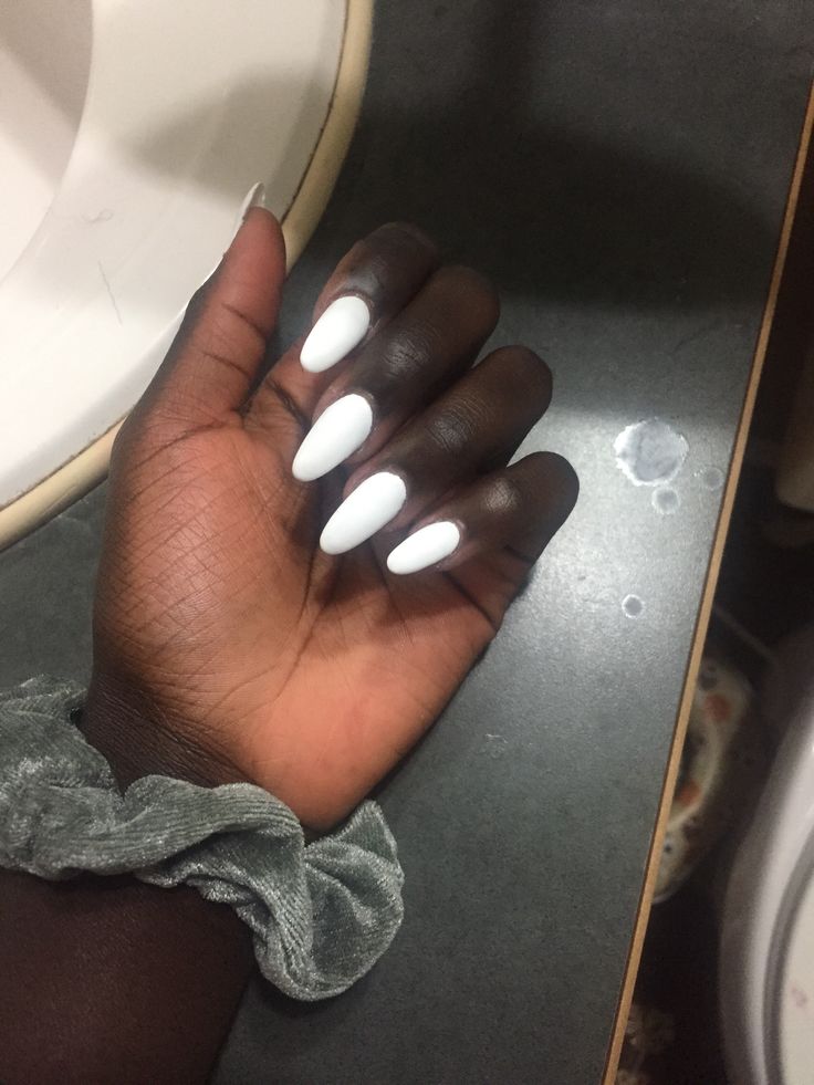 Chic Almond-Shaped Nails and Gray Scrunchie: A Striking Contrast Against Deep Brown Skin.