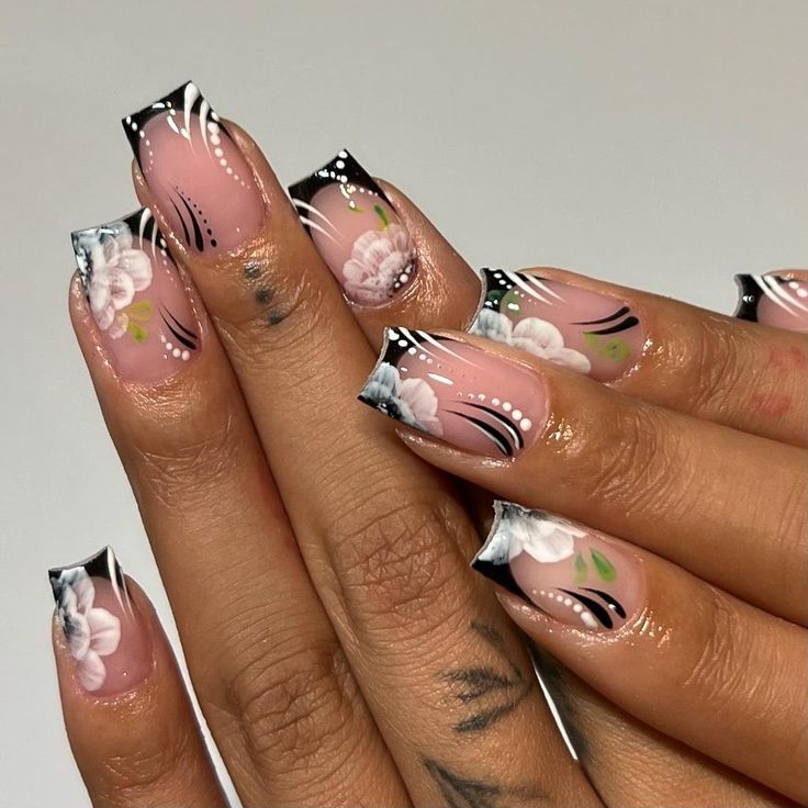 Sophisticated Nail Design: Soft Pink Base with Floral Accents and Bold Contrast