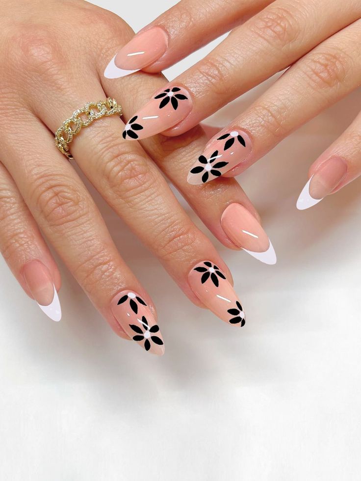 Chic Almond-Shaped Nail Art Blends Polished Nude Finish with Bold Floral Accents.