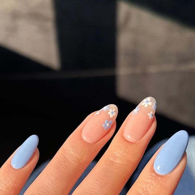 Charming Pastel Nail Design: Soft Pink and Blue with Floral Accents for a Fresh Spring Look.