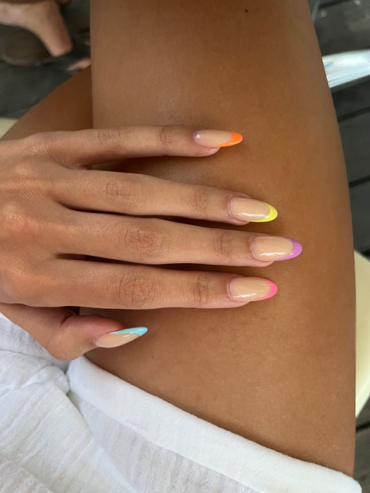 Vibrant Ombre Nail Design with Colorful Tips on a Nude Base for a Fun Summer Look.