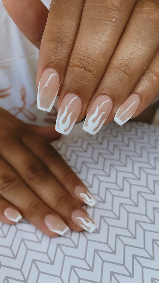 Chic Flame-Inspired French Tip Nail Design in Nude and White.