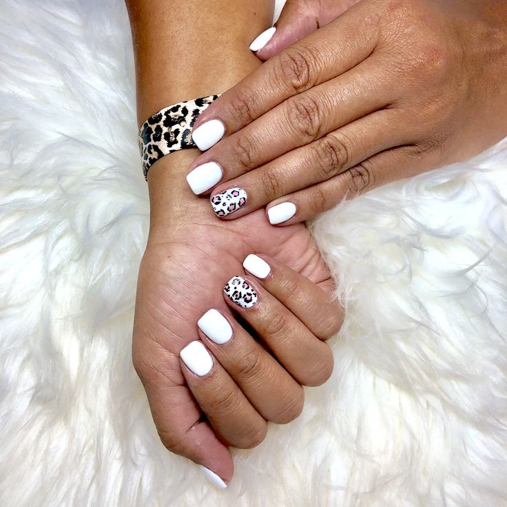 Chic White Nails with Bold Leopard Accents for a Stylish Statement.