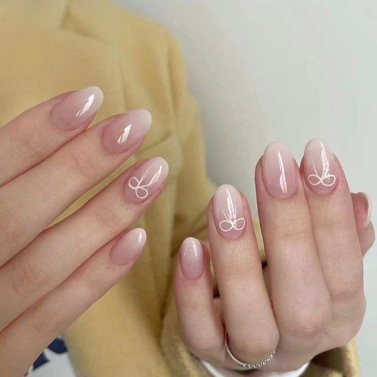 Chic Ombre Nails: Nude to Light Pink Gradient with Delicate Artistic Tips.