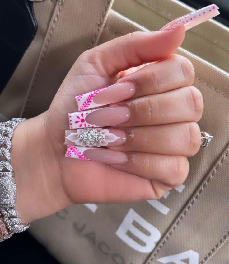 Chic Soft Nude Acrylic Nails with Playful Pink Patterns and Floral Details.