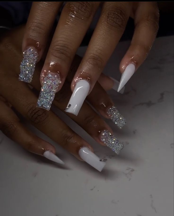 Dazzling Textured Nail Design with Glossy White Polish and Vibrant Rhinestones