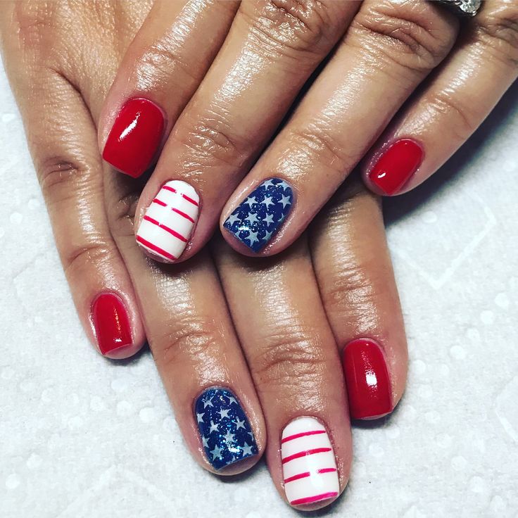 Festive Patriotic Nail Design in Red, White, and Blue with Star Patterns and Stripes.