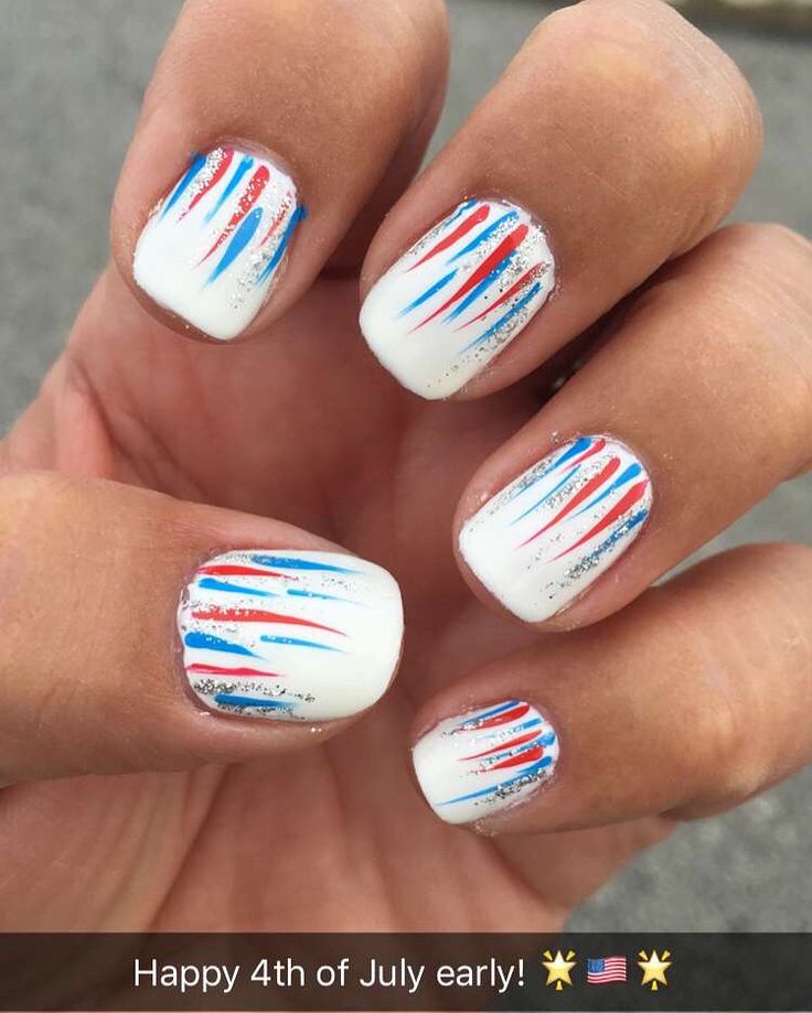 Vibrant Nail Art: Festive Red and Blue Stripes on a White Base with Sparkles.