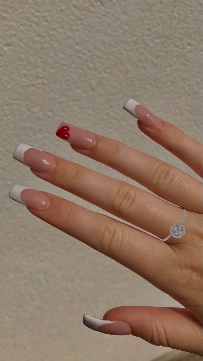 Sophisticated French Tip Nail Design with Whimsical Red Accent.