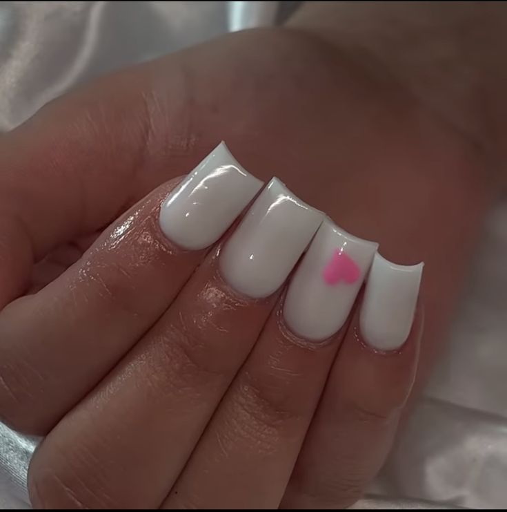 Chic White Nails with Glossy Finish and Playful Pink Heart Accent