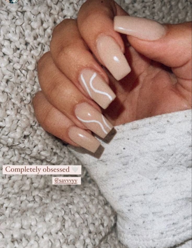 Chic and Sophisticated Elegant Nude Nail Design with Glossy Finish and White Accents