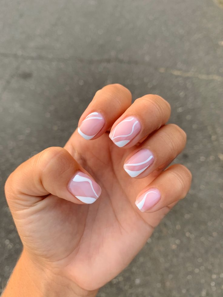 Elegant Soft Pink Nail Design with White Accents for a Playful, Sophisticated Look.