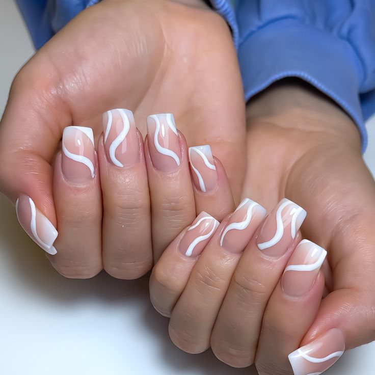 Chic Nude Nails with Contrasting White French Tips and Fluid Patterns.