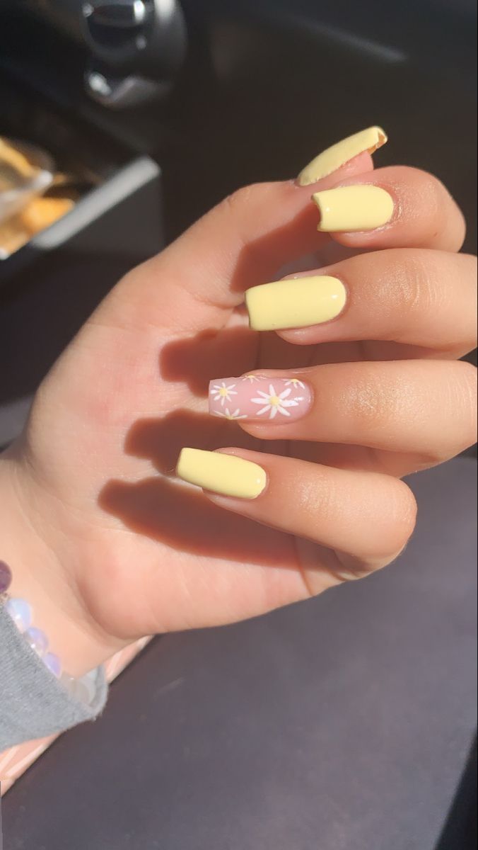 Cheerful Spring-Inspired Nail Design: Vibrant Yellow with Pastel Accent and Floral Touch