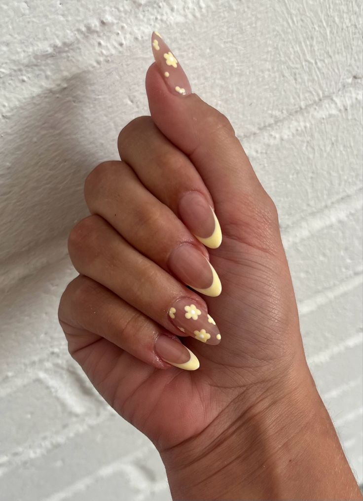 Chic Elongated Almond Nails with Soft Nude and Pastel Yellow for a Playful Spring Elegance.