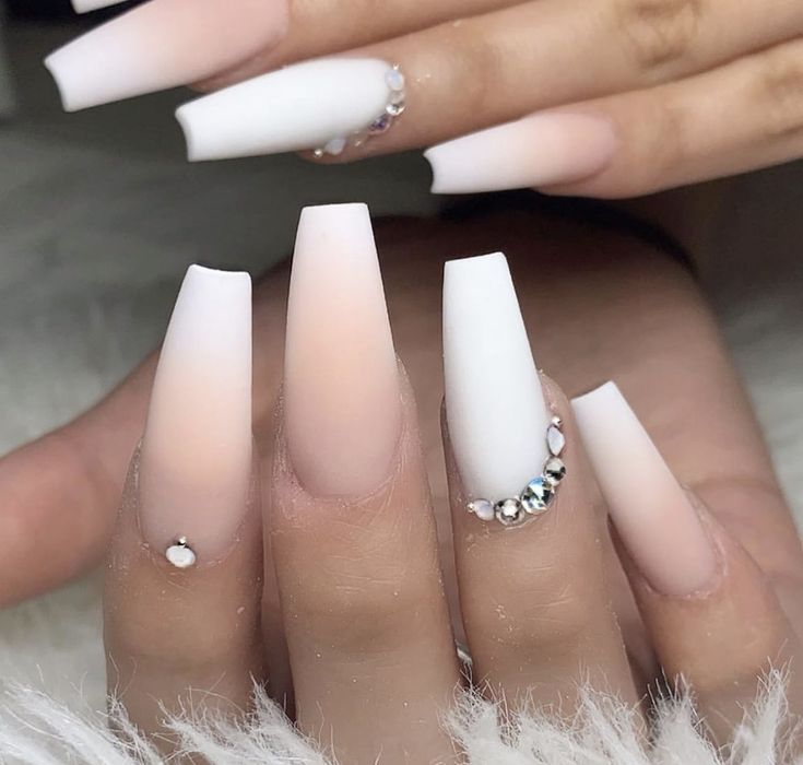 Elegant Ombre Nail Design: Soft Pink and White Gradient with Sparkling Embellishments.