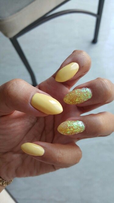 Cheerful Yellow Nails with Sparkling Glitter for a Fun and Stylish Look.