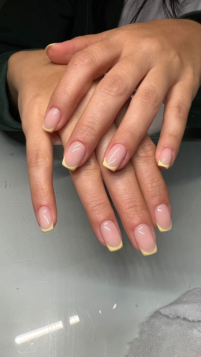 Sophisticated French Manicure with Vibrant Yellow Tips for a Fresh Look.