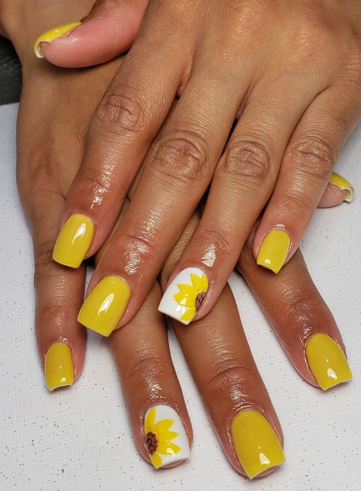 Cheerful Summer Nail Design: Vibrant Yellow with Playful Sunflower Art and Glossy Finish.