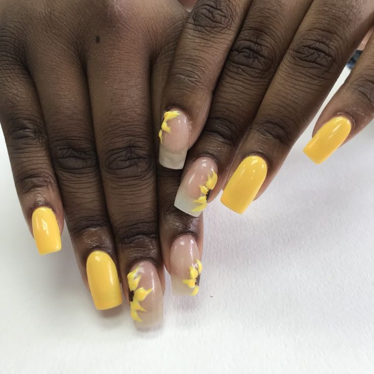 Cheerful Yellow Nail Design with Artistic Floral Accents