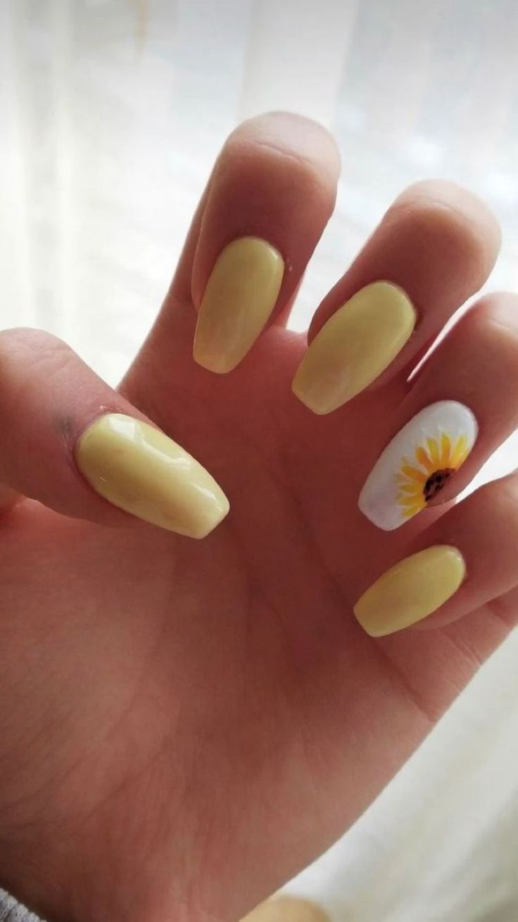 Bright and Cheerful Yellow Nails with Playful Sunflower Accent for a Sunny Vibe.