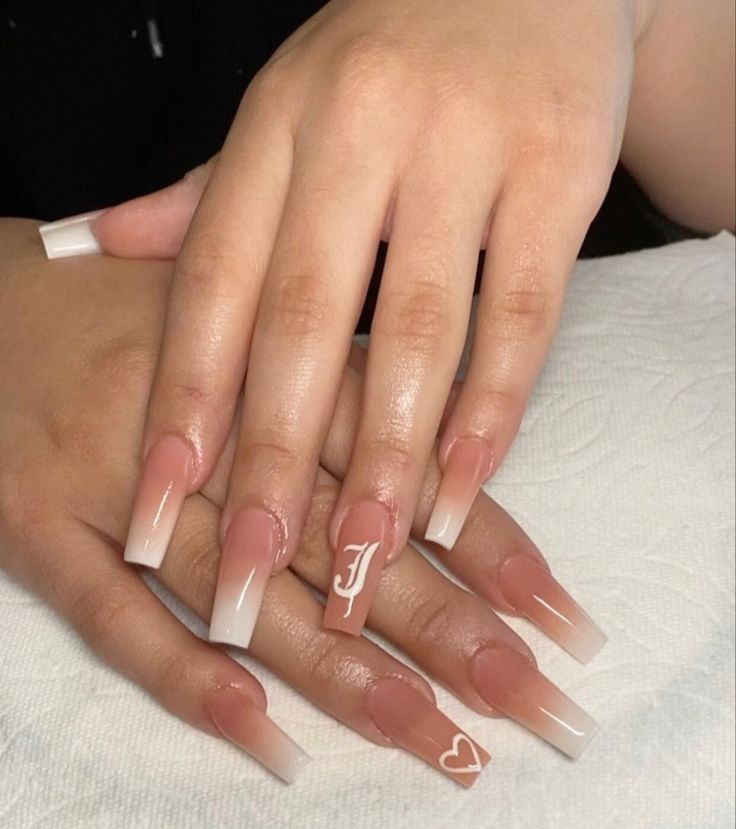 Chic Ombre Nails with Unique Accents and Heart Symbols.