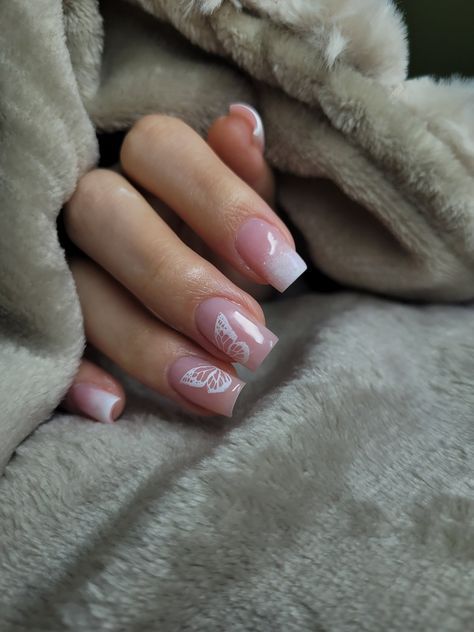 Chic Soft Pink and White Nail Design with Whimsical Butterfly Graphic and Gradient Effect.