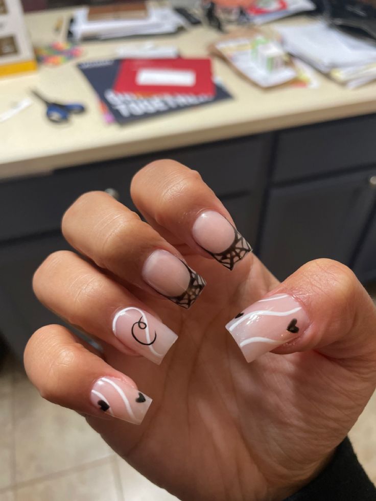 Chic Soft Pink and White Nail Design with Intricate Patterns and Heart Accents