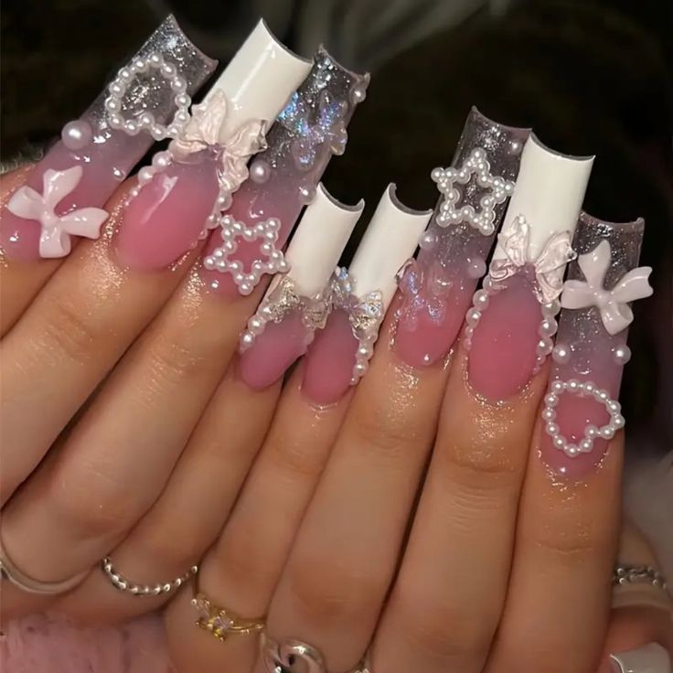 Charming Elegant Nail Design with Soft Pink, Glitter Accents, and Intricate Embellishments.