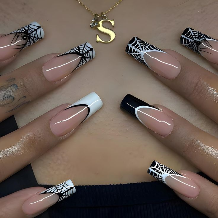 Chic Gothic Nail Design with Nude and Dark Shades and Spider Web Patterns.