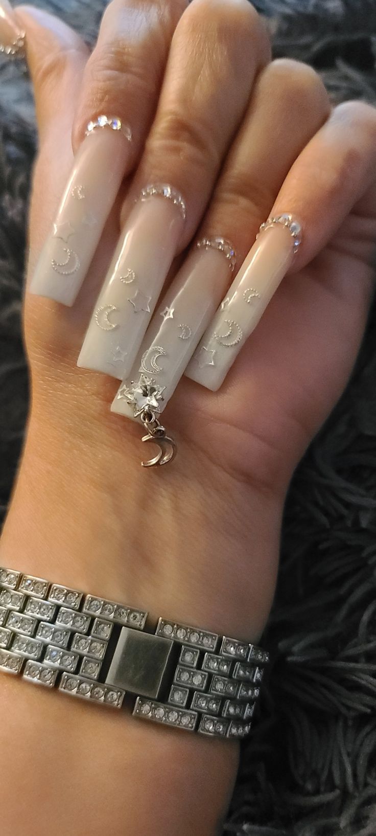 Elegant Long Nails with Celestial Designs and Glamorous Rhinestone Accents.