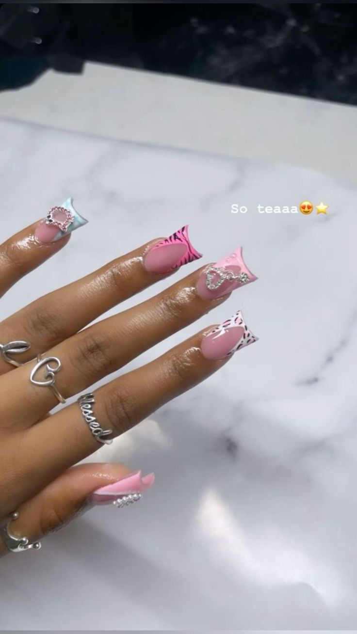 Trendy Pastel Pink Leopard Print Nail Design with Glam Rhinestones and Silver Rings