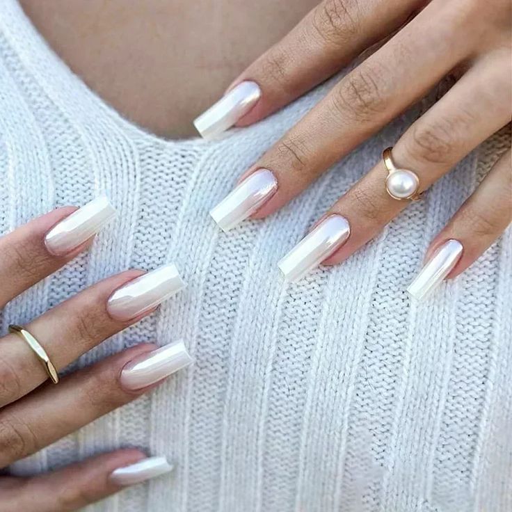 Chic & Sophisticated: Glossy White Long Square Nails with Iridescent Highlights and Minimalist Gold Rings.