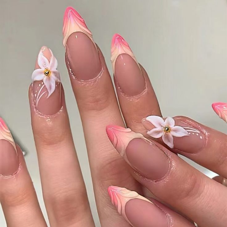 Stunning Elegant Pink Ombre Nails with Floral Embellishments and Tapered Shape.