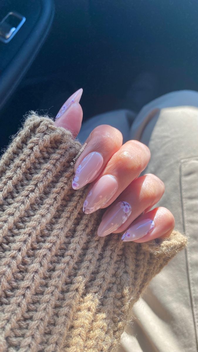 Chic Almond-Shaped Nails with Soft Nude Base and Delicate Purple Floral Accents