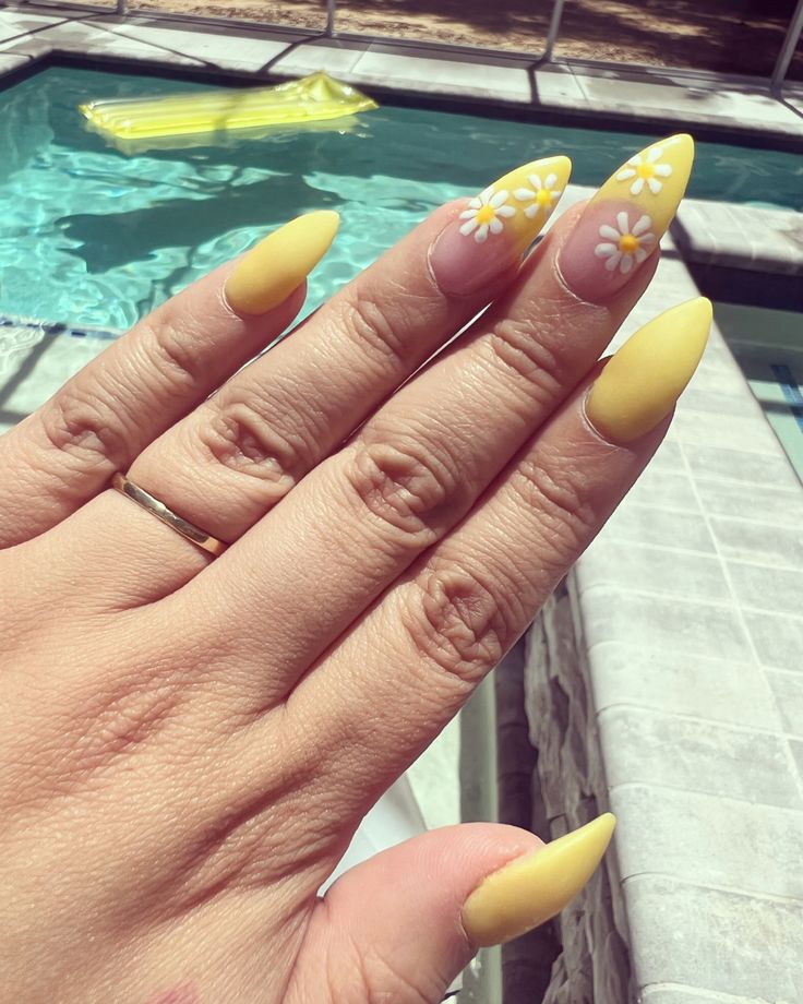 Cheerful Summer-Inspired Yellow Nail Design with Delicate White Daisy Accents.