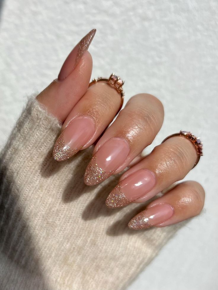 Elegant Almond-Shaped Nails with Shimmering Gold Glitter Tips: A Sophisticated Look for Any Occasion.