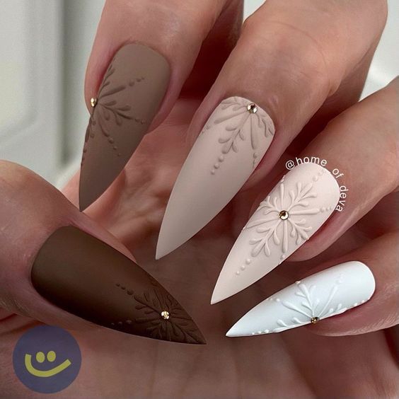 Sophisticated Almond-Shaped Nail Design with Matte Earthy Tones, Soft Pastels, and Floral Embellishments.