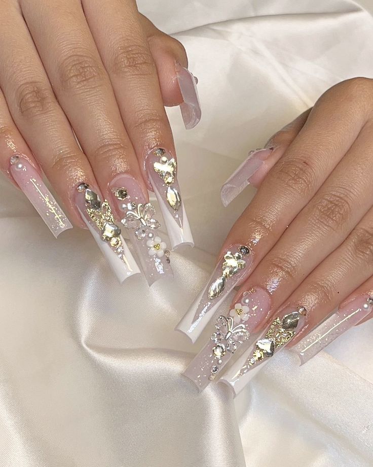 Elegant French Tip Nail Design with Floral Patterns and Gem Accents.