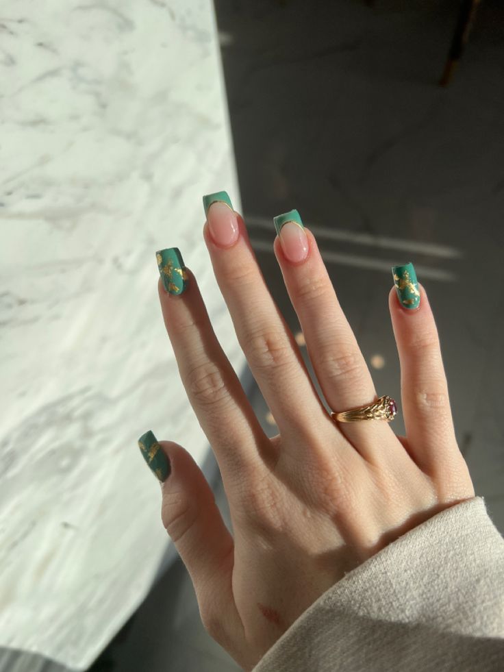 Chic Teal and Nude Nail Design with Whimsical Floral Accents.