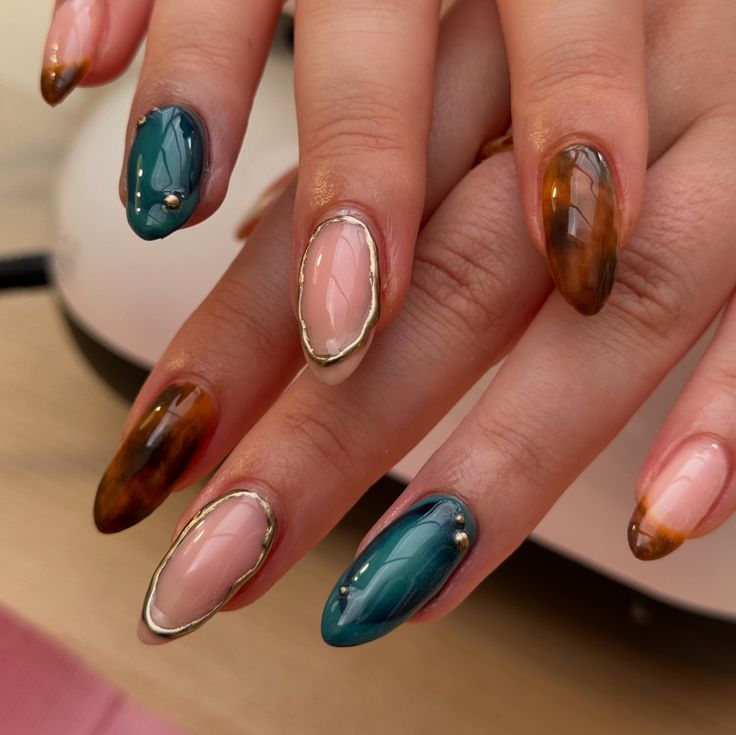 Elegant Nail Design with Deep Teal, Warm Brown, and Soft Pink Hues adorned with Gold Detailing.