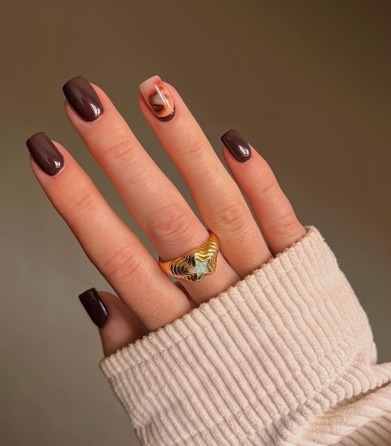 Sophisticated Brown Nail Design with Chic Swirl Accent and Bold Ring.