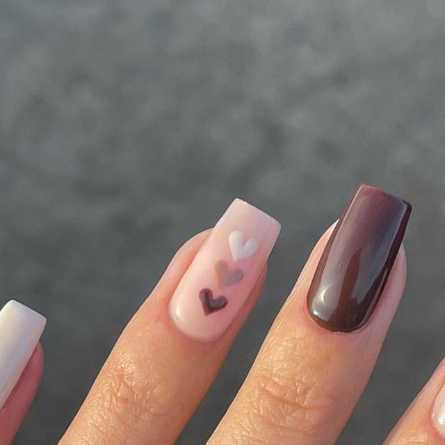 Elegant Chic Nail Design: Soft Pastels and Dark Shades with Playful Heart Motifs