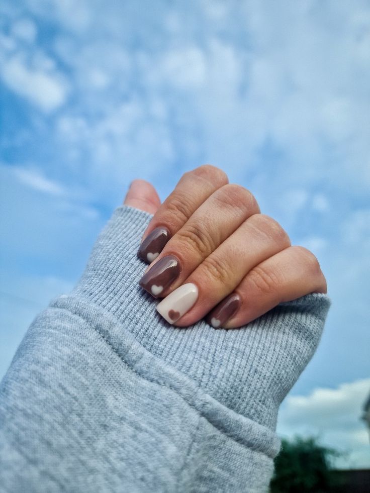 Chic Gradient Nail Design: Rich Brown and Soft Nude with Heart Accents