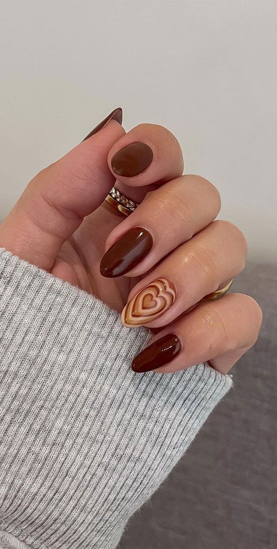 Chic Brown Nail Design with Heart Accent and Cozy Texture.